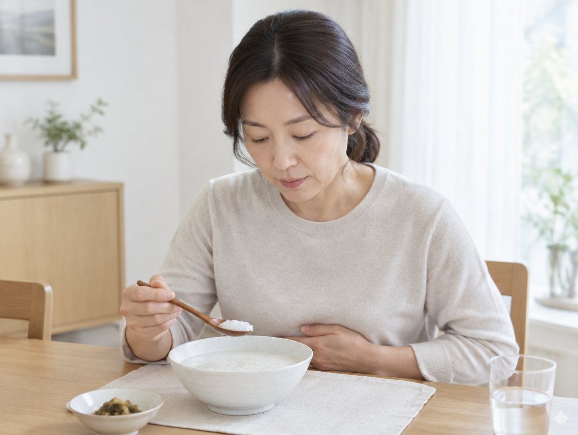 吃粥時手放上腹部的女性